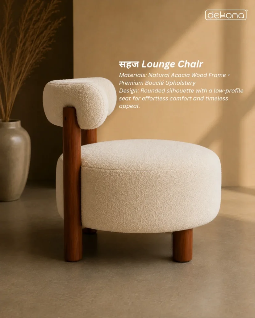 A bouclé lounge chair with a wooden frame in a warm, minimal interior